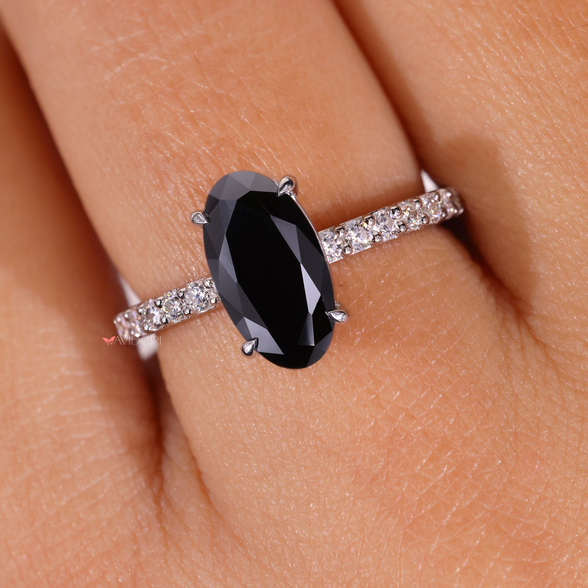 Claw prong engagement ring featuring a moissanite center stone.
