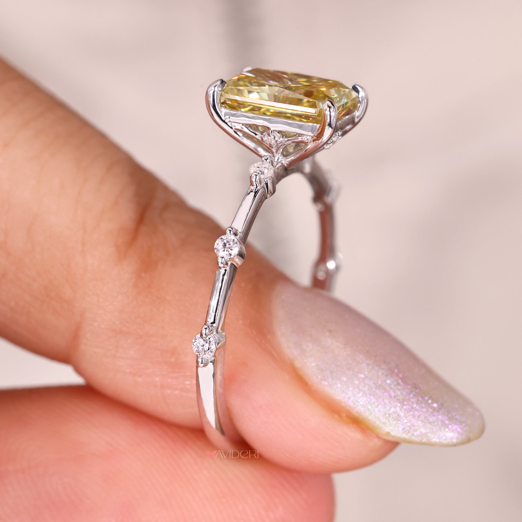 A distance pave round cut ring rests elegantly on her finger.