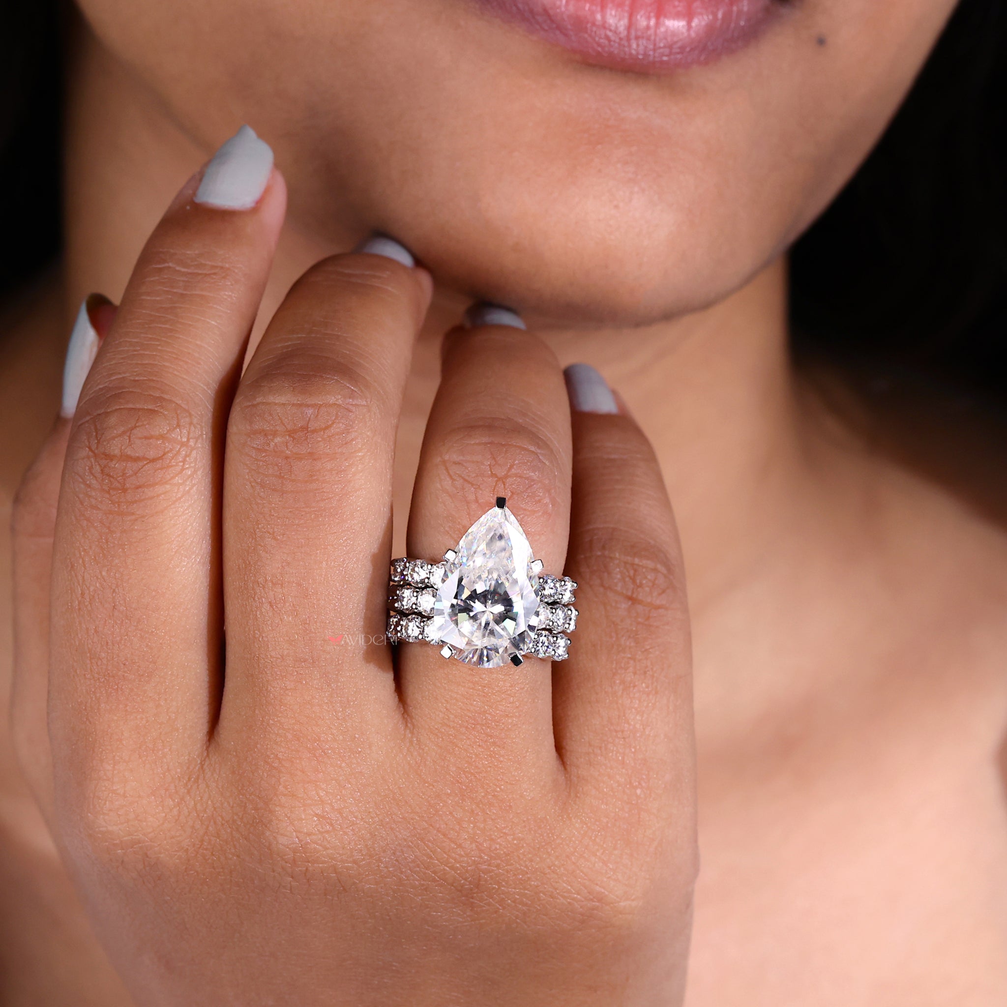 Round Cut Pave Set Band adds a classic touch to the pear engagement ring.