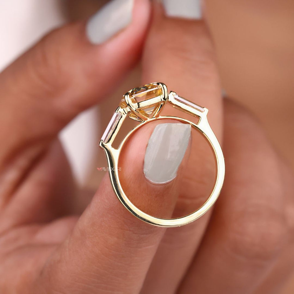 Yellow gold ring with a radiant emerald cut center
