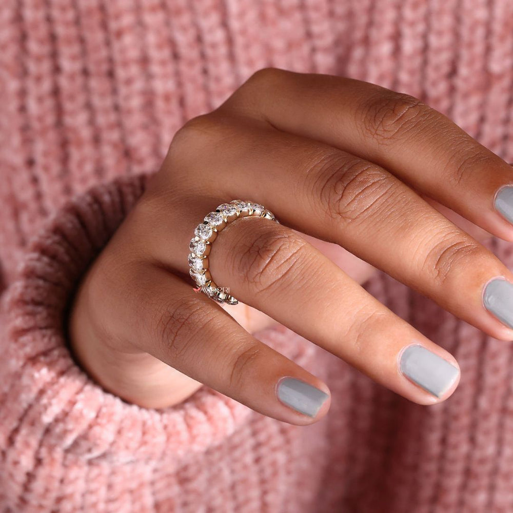 A Moissanite gold wedding band combines sparkle with warmth.