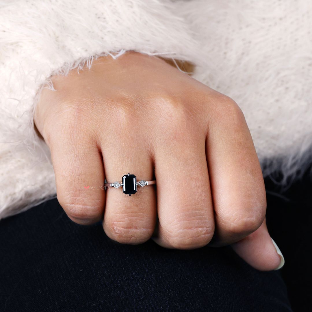 Milgrain engagement ring with intricate detailing and a cathedral setting.
