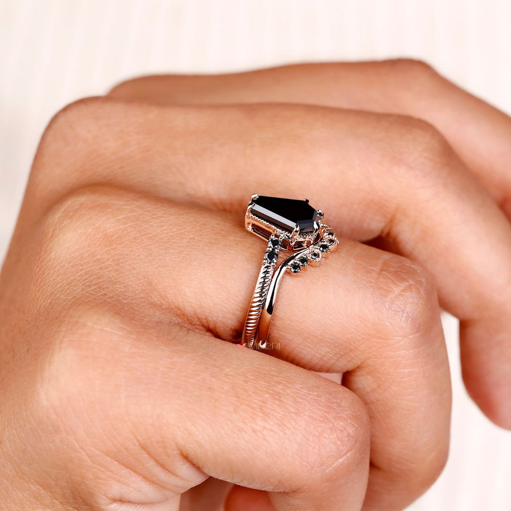 Curved wedding band paired with a coffin engagement ring for a perfect match.
