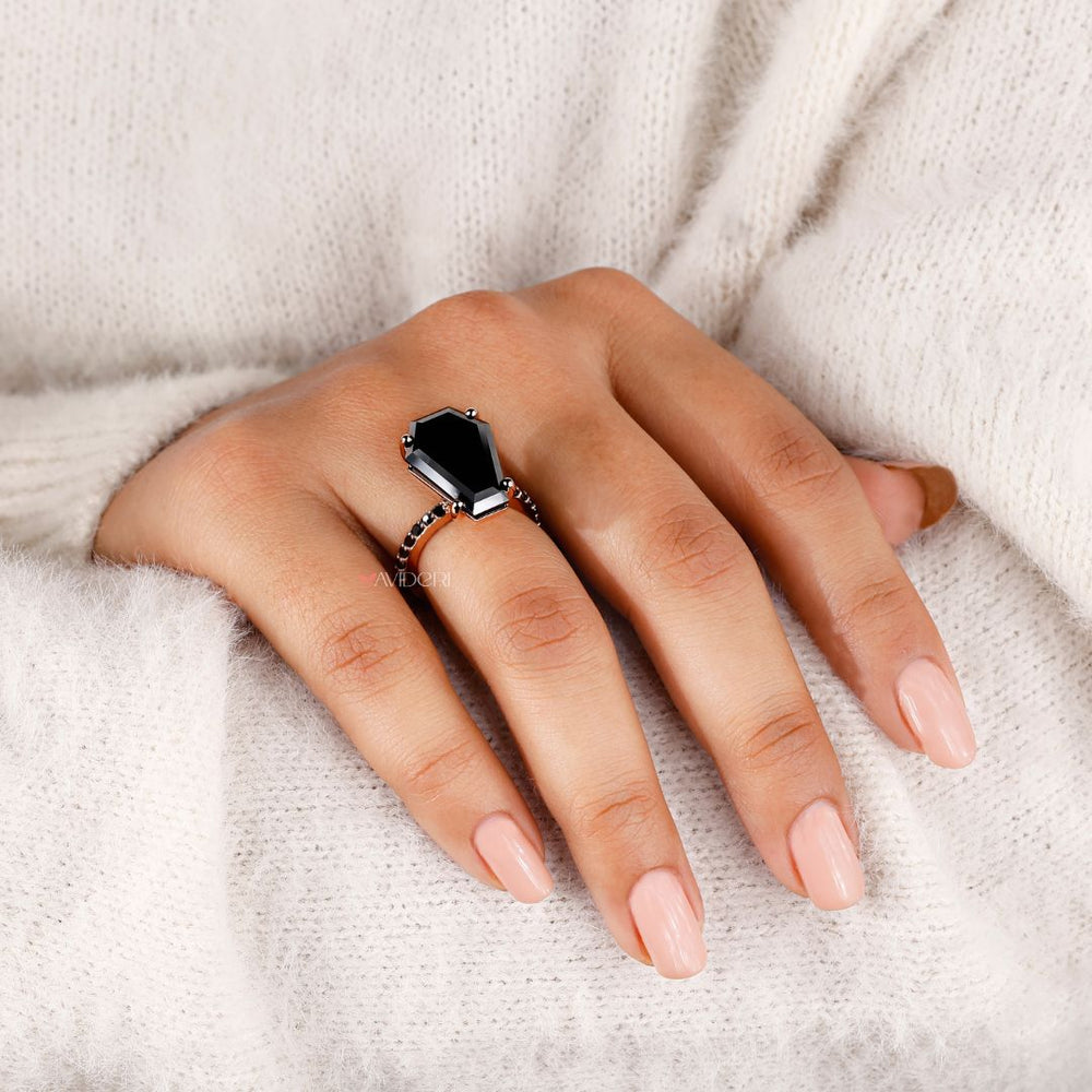 Handmade jewelry featuring a bold coffin engagement ring design.
