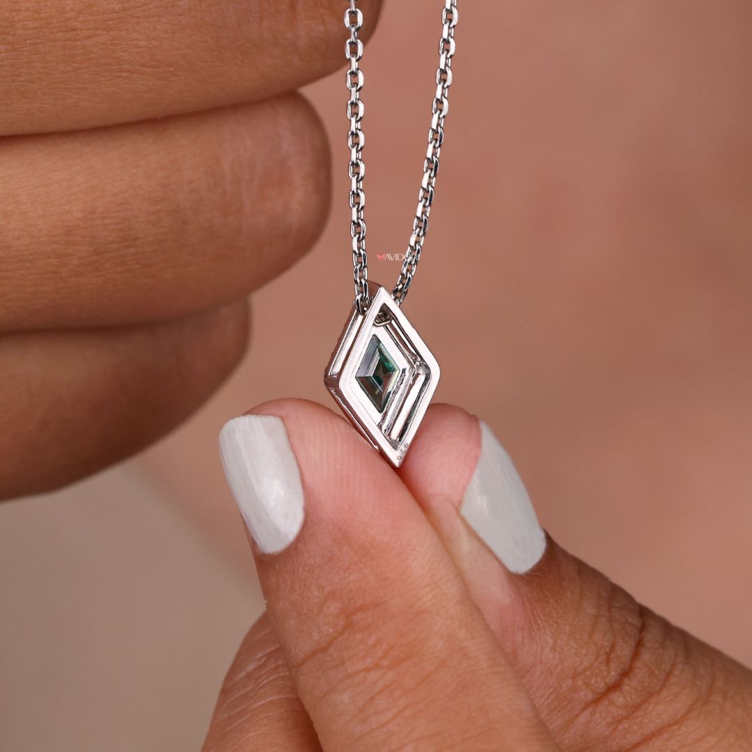 White gold pendant featuring a lozenge cut moissanite stone.
