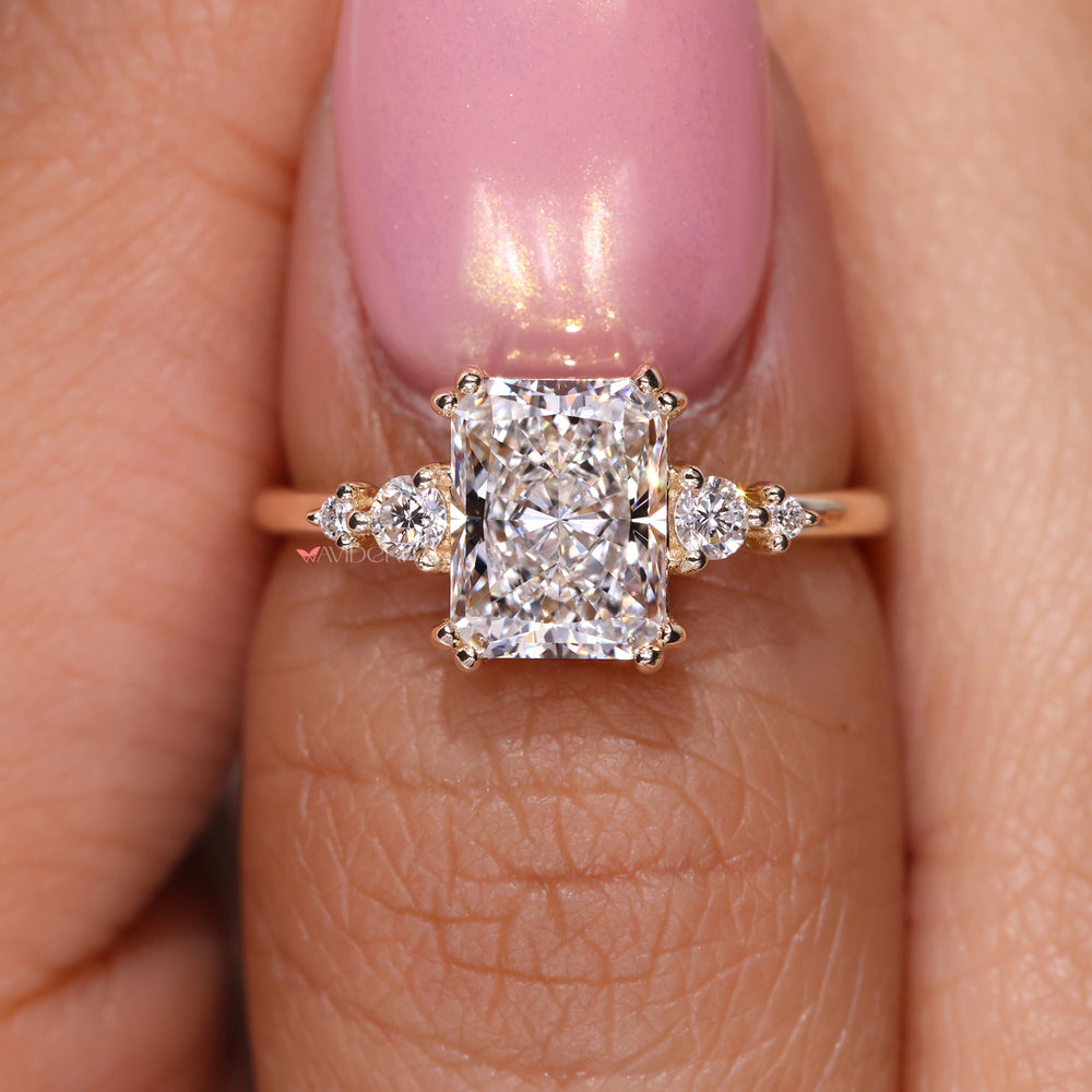 Round diamond ring set with a radiant cut diamond for timeless beauty.
