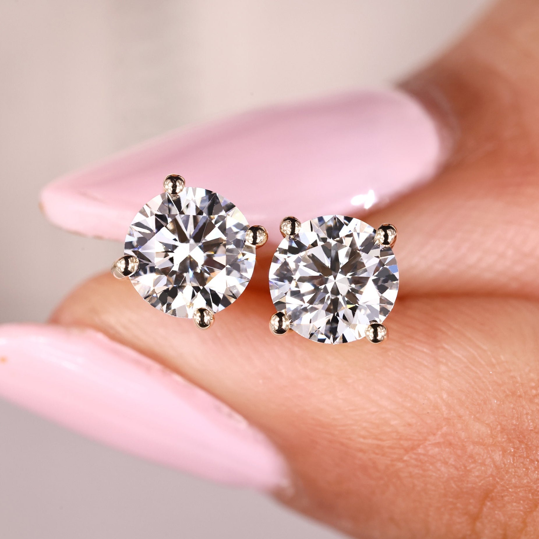 5mm round cut diamond earrings in yellow gold.