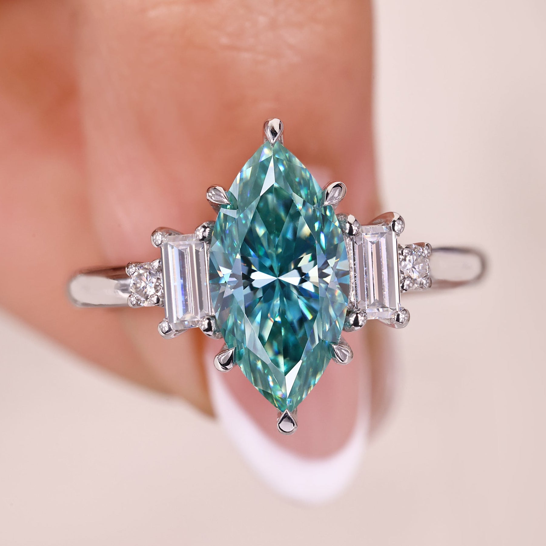 5 stone engagement ring with cyan blue moissanite ring.