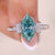 5 stone engagement ring with cyan blue moissanite ring.
