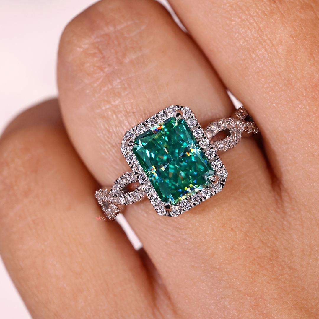Halo engagement ring adorned with a cyan blue moissanite gemstone.
