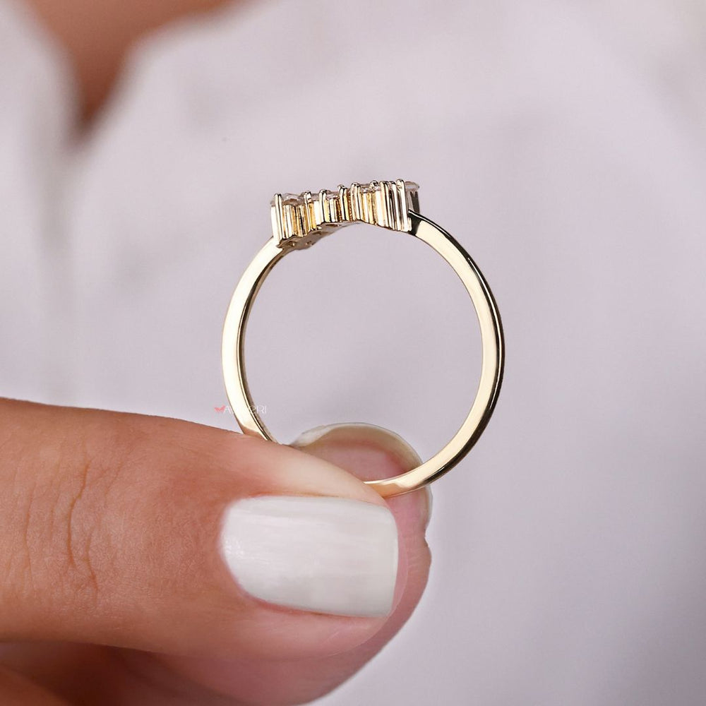 A yellow gold custom engagement ring with a simple band.
