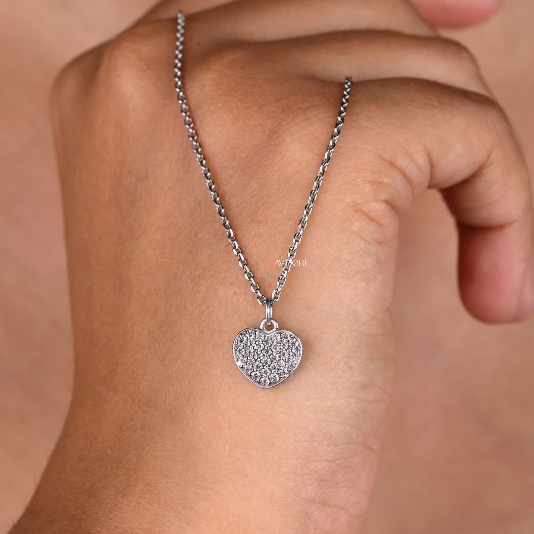 Minimalist pendant with a heart shape and round moissanite cut stone.

