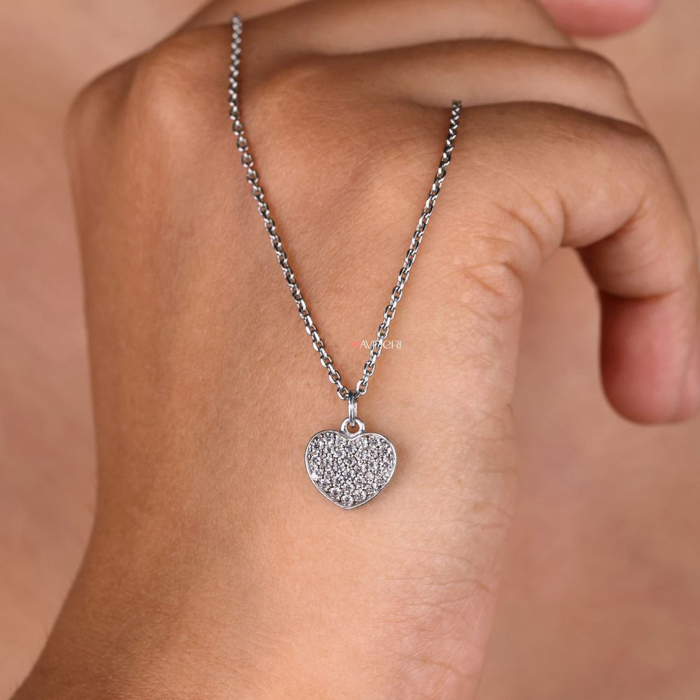 Minimalist pendant with a heart shape and round moissanite cut stone.

