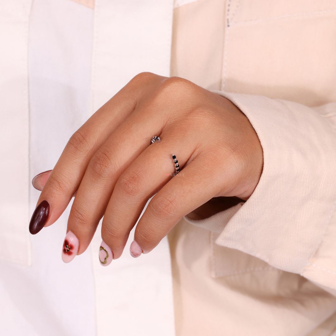 A black moissanite wedding band adds bold contrast and style.