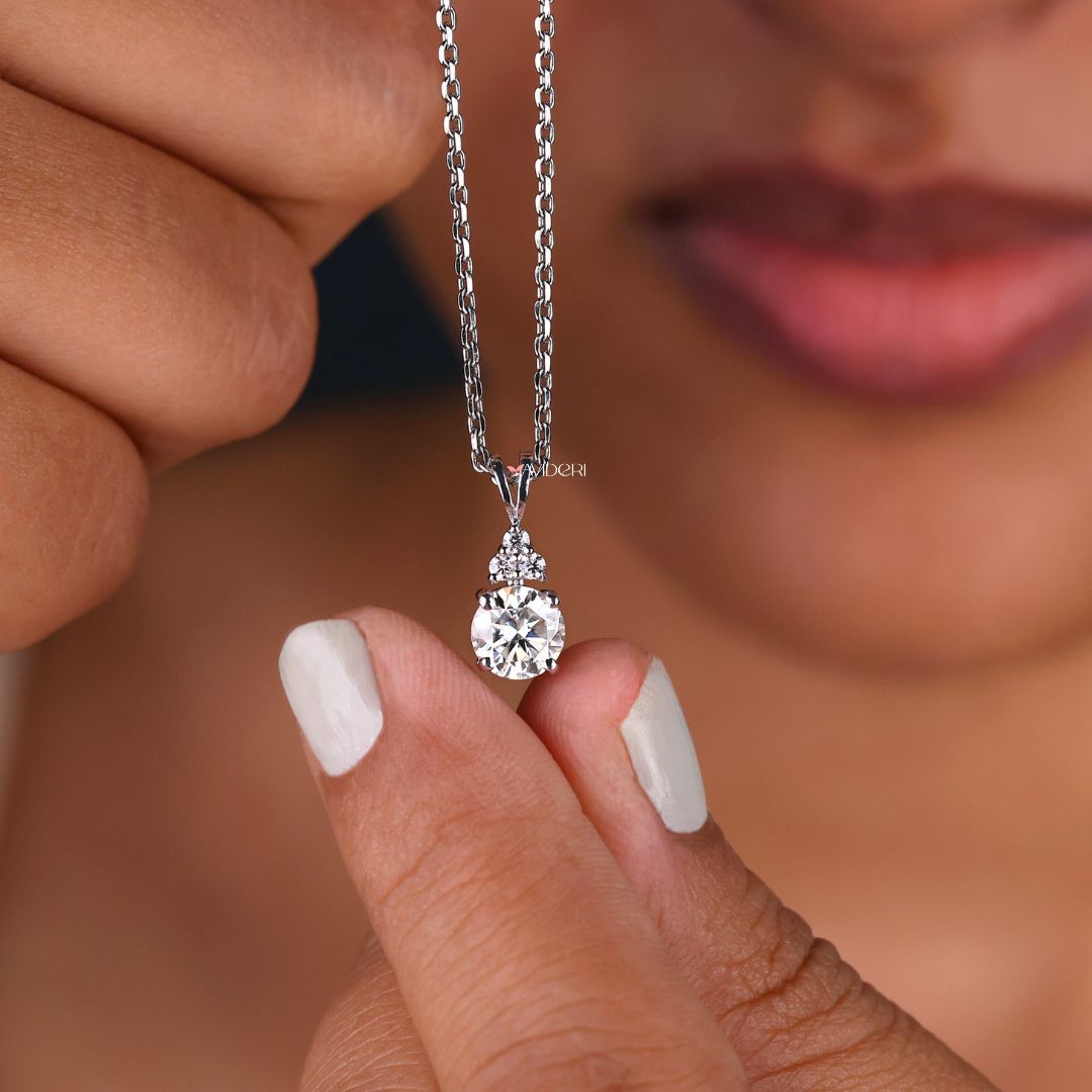 Moissanite pendant with a round cut stone in a sleek white gold setting.
