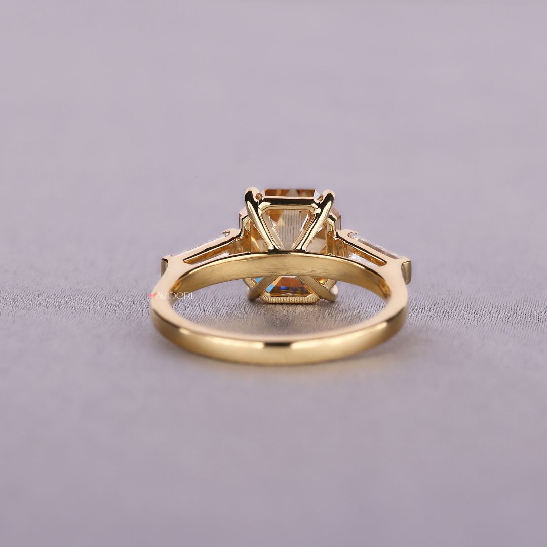 Yellow gold engagement ring featuring three stone design

