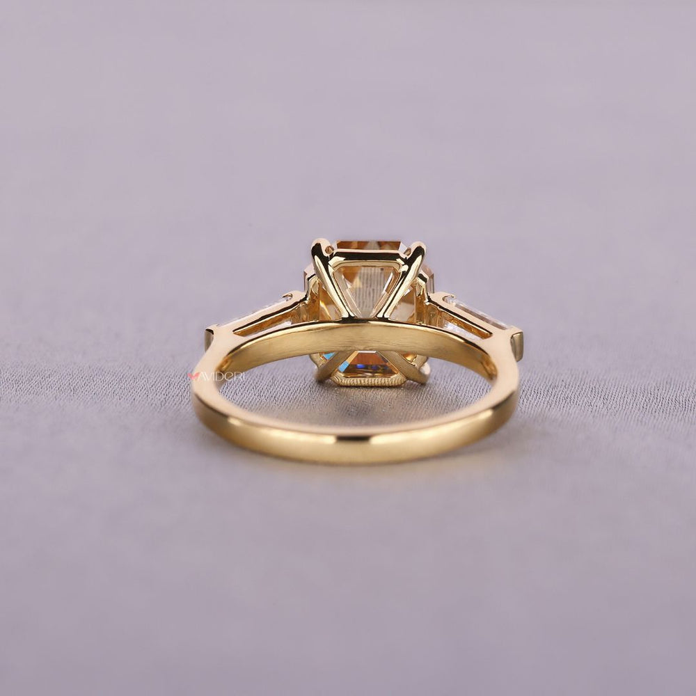 Yellow gold engagement ring featuring three stone design
