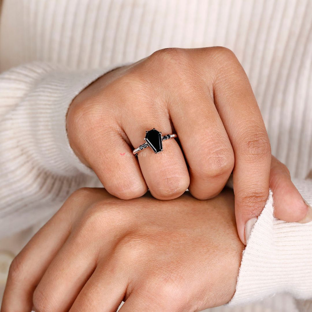 Avideri engagement ring featuring a unique coffin ring design with a round cut stone.
