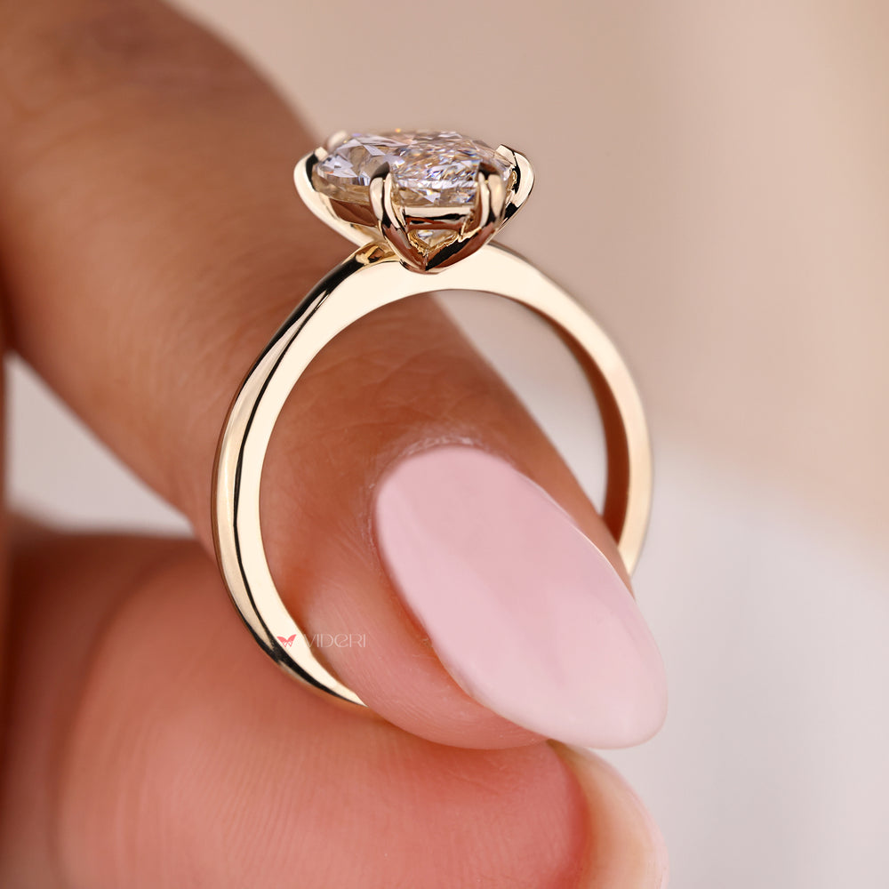 Yellow gold ring with a beautiful Marquise diamond center.
