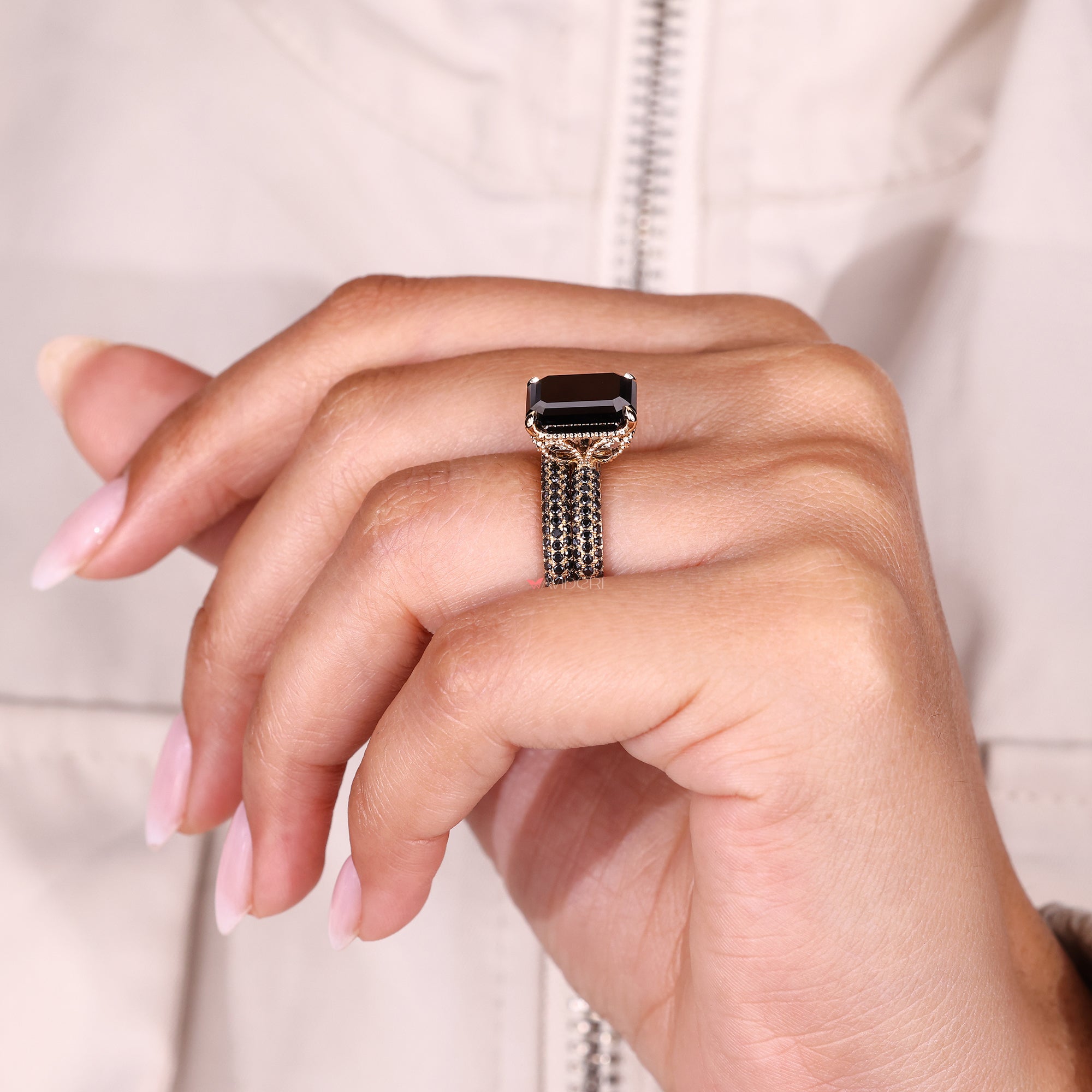4 claw prong ring with an emerald cut moissanite stone for a secure setting.