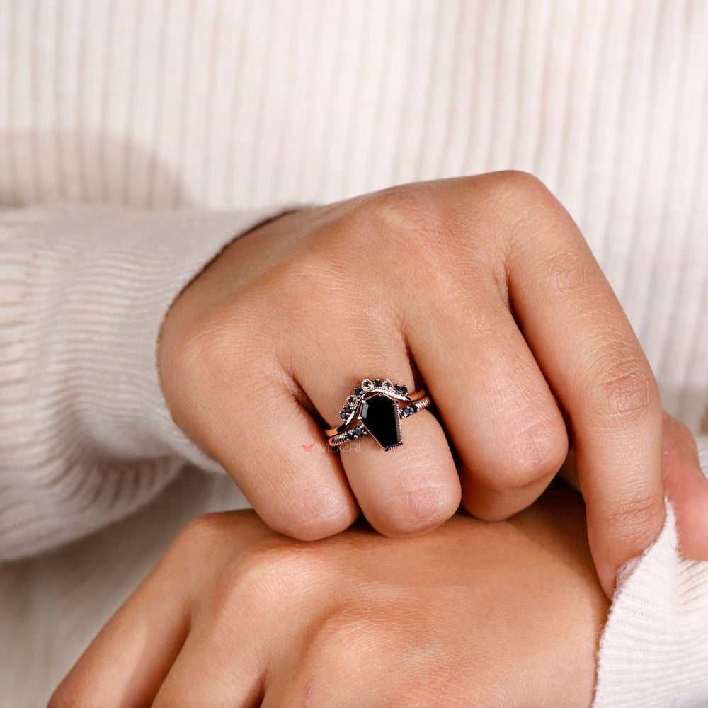 Round cut ring with a unique coffin engagement ring style.