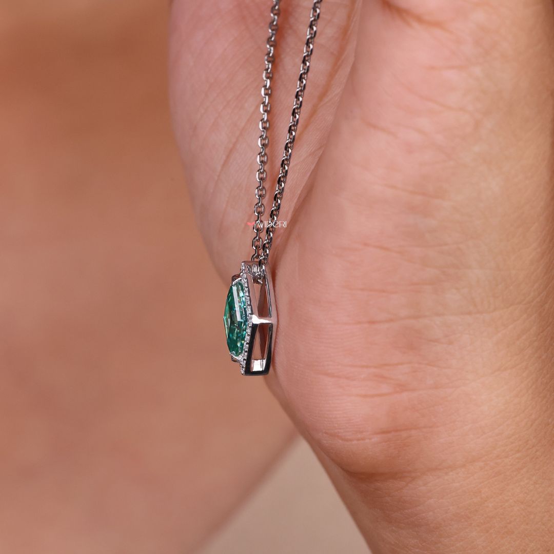 Avideri pendant with a lozenge cut moissanite stone in a halo design.
