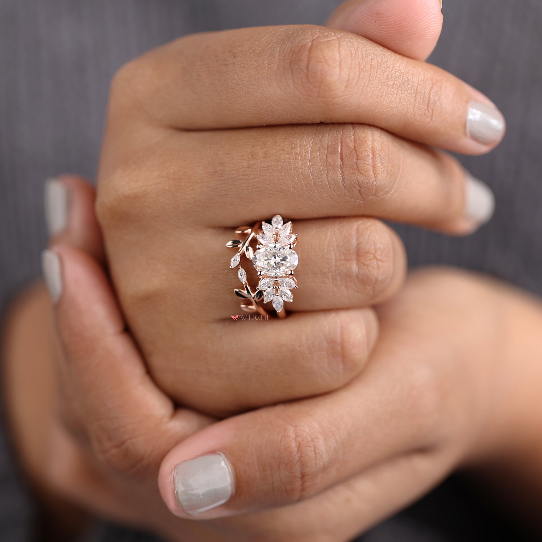 Oval cut ring paired with a marquise cut ring in a leaf style design.
