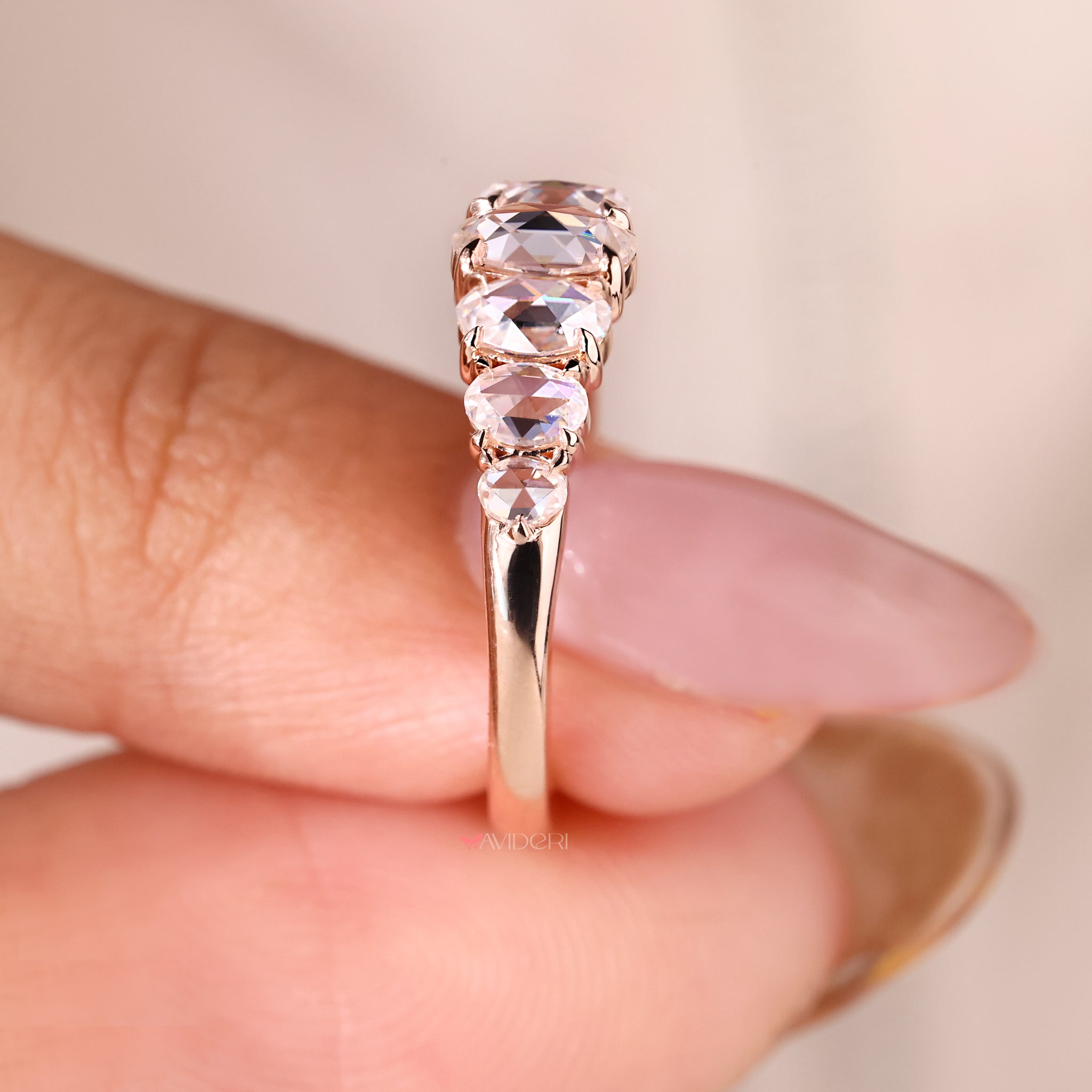 Claw prong setting on an oval rose cut wedding band for a secure fit.