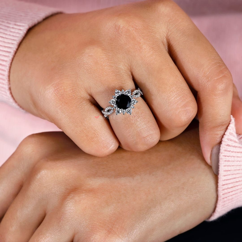 Infinity shank engagement ring featuring a round cut center stone.
