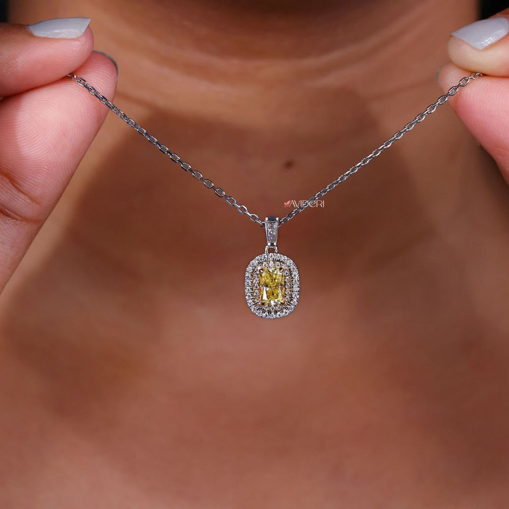 Customizable pendant with double halo and round cut moissanite.