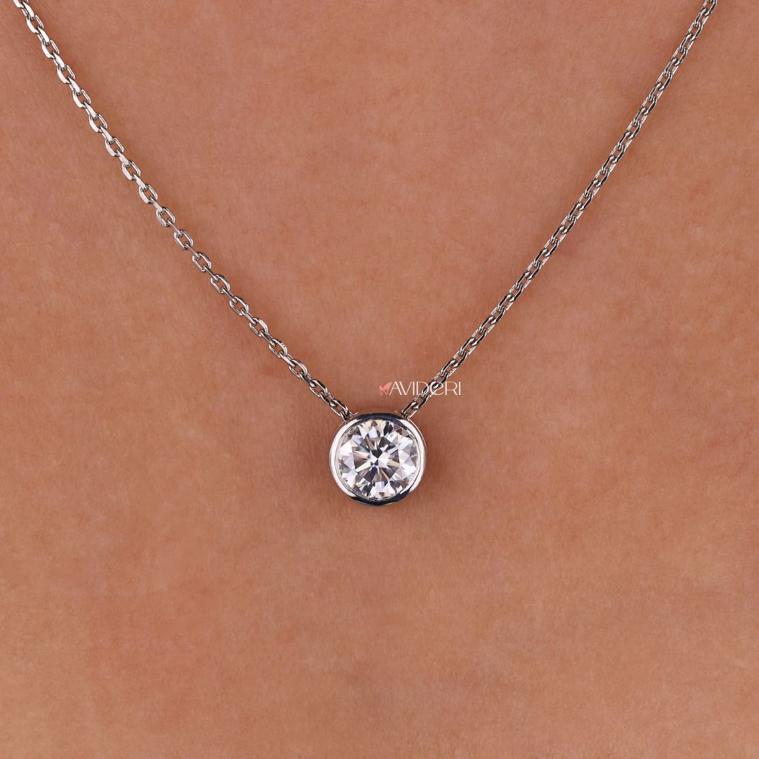 Handmade pendant featuring a round moissanite stone in a solitaire setting.
