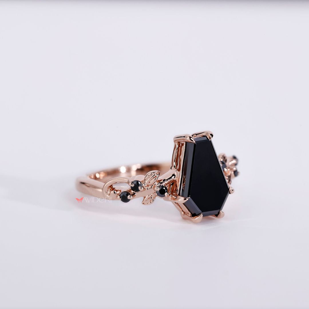Black moissanite ring set in a coffin engagement ring for a bold look.
