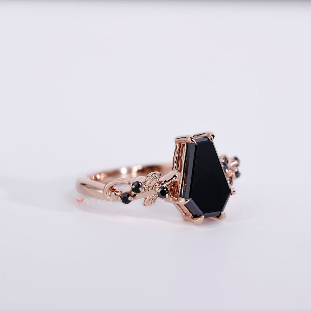 Black moissanite ring set in a coffin engagement ring for a bold look.
