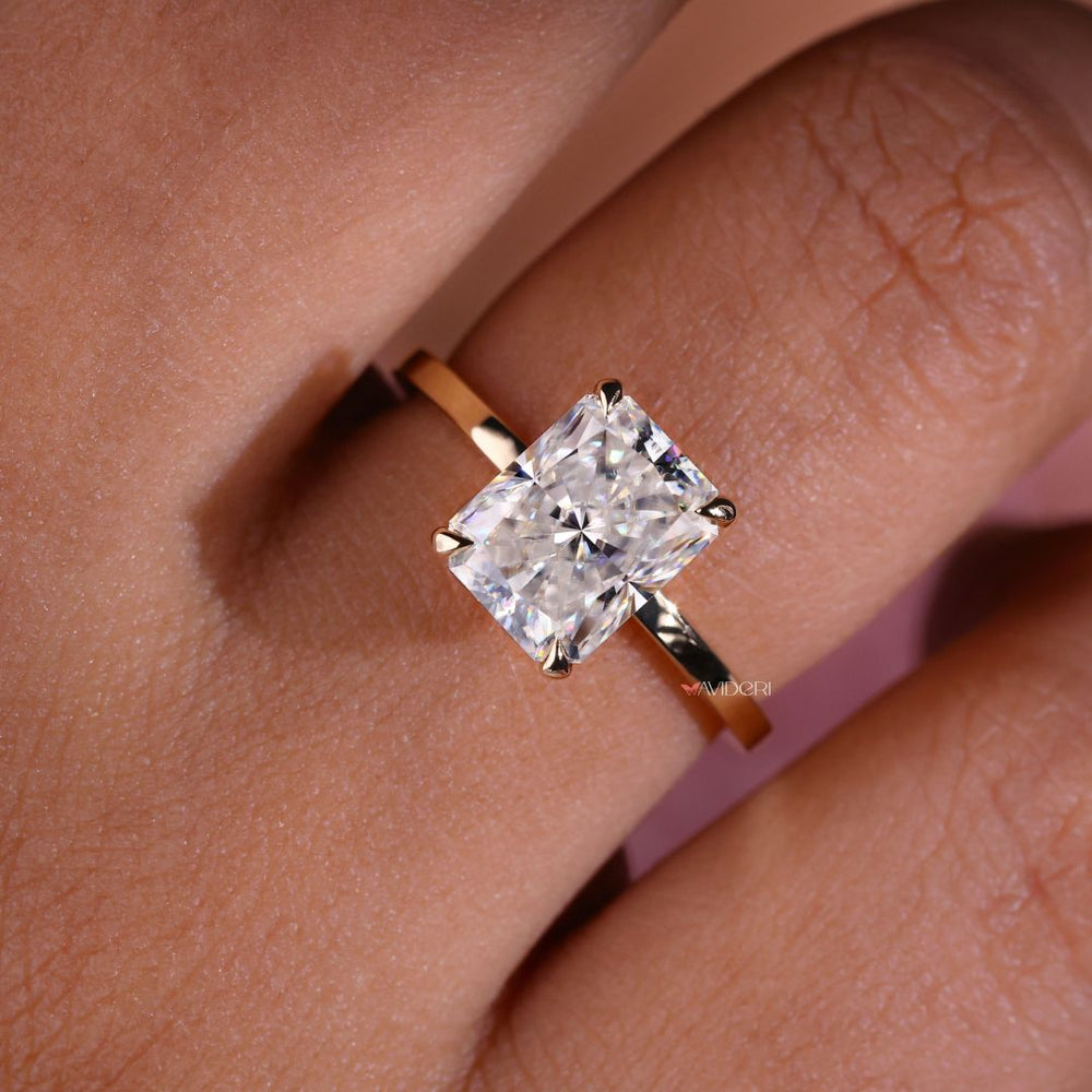 Radiant cut moissanite ring gold featuring a brilliant cut stone.
