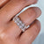 Round halo eternity band in yellow gold.