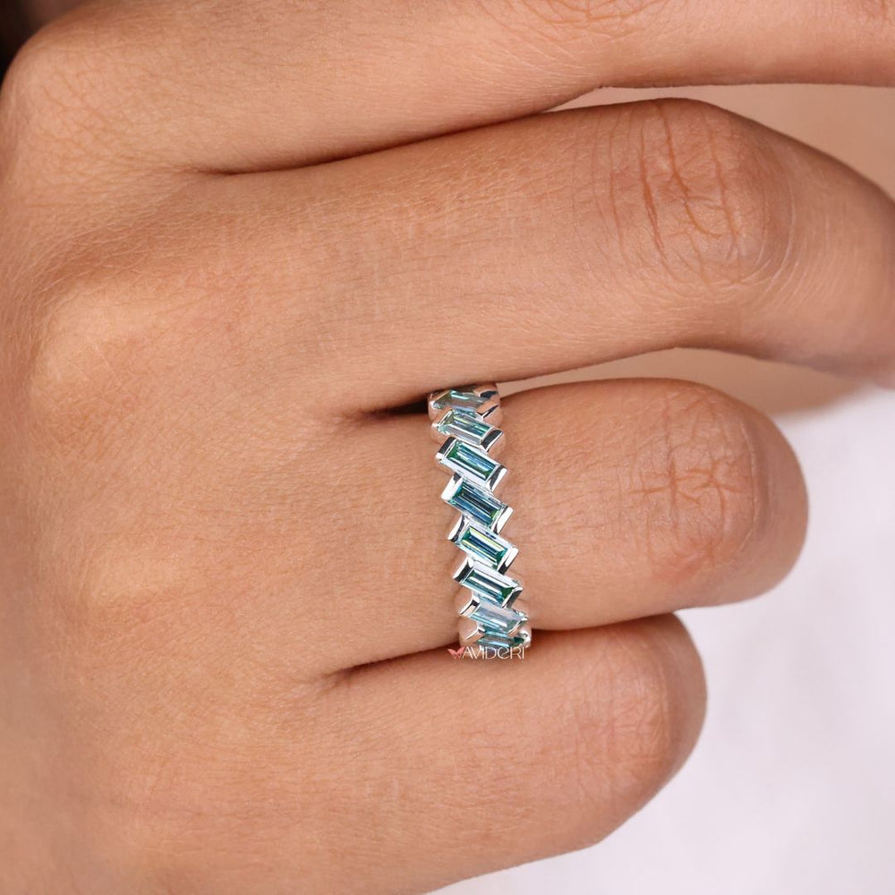 Bezel set band secures stones with modern, sleek edges for a minimalist style.
