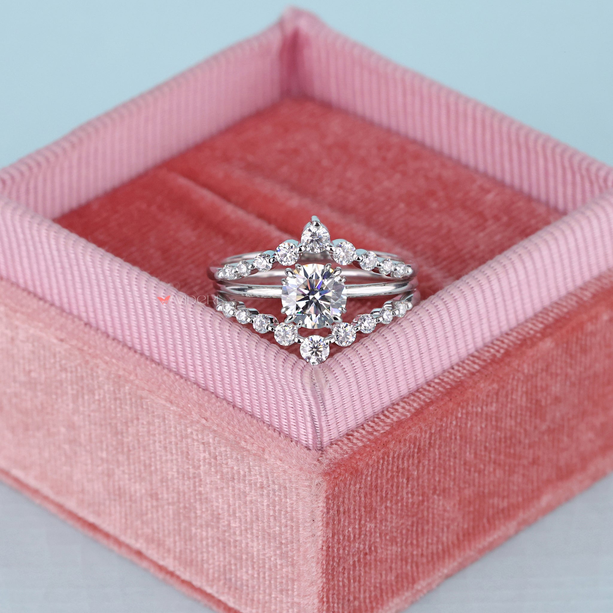 Shared prong wedding band with a round cut solitaire center.
