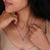 Lozenge moissanite pendant set in a white gold design.
