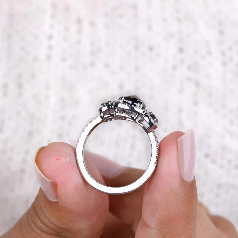 White gold ring with a cushion cut moissanite center stone.
