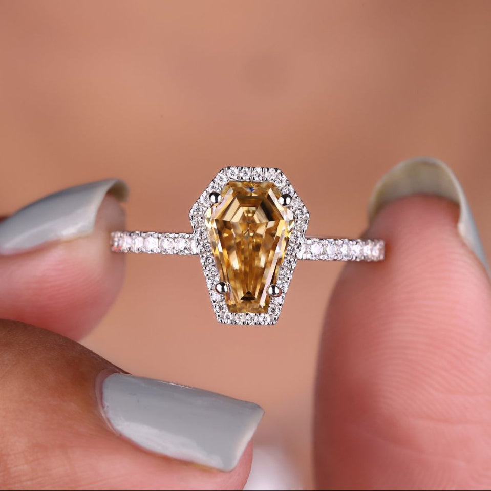 Coffin round cut ring with a unique design.
