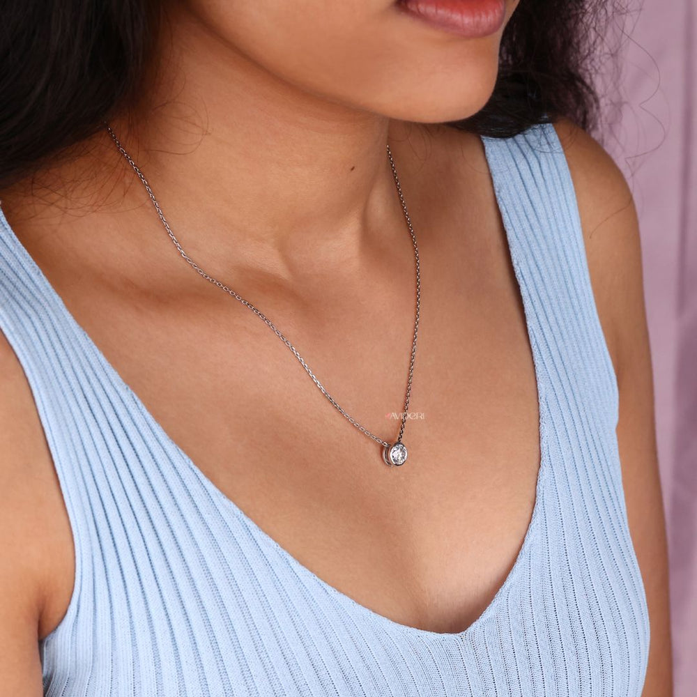 Avideri pendant with a round cut moissanite stone set in white gold.
