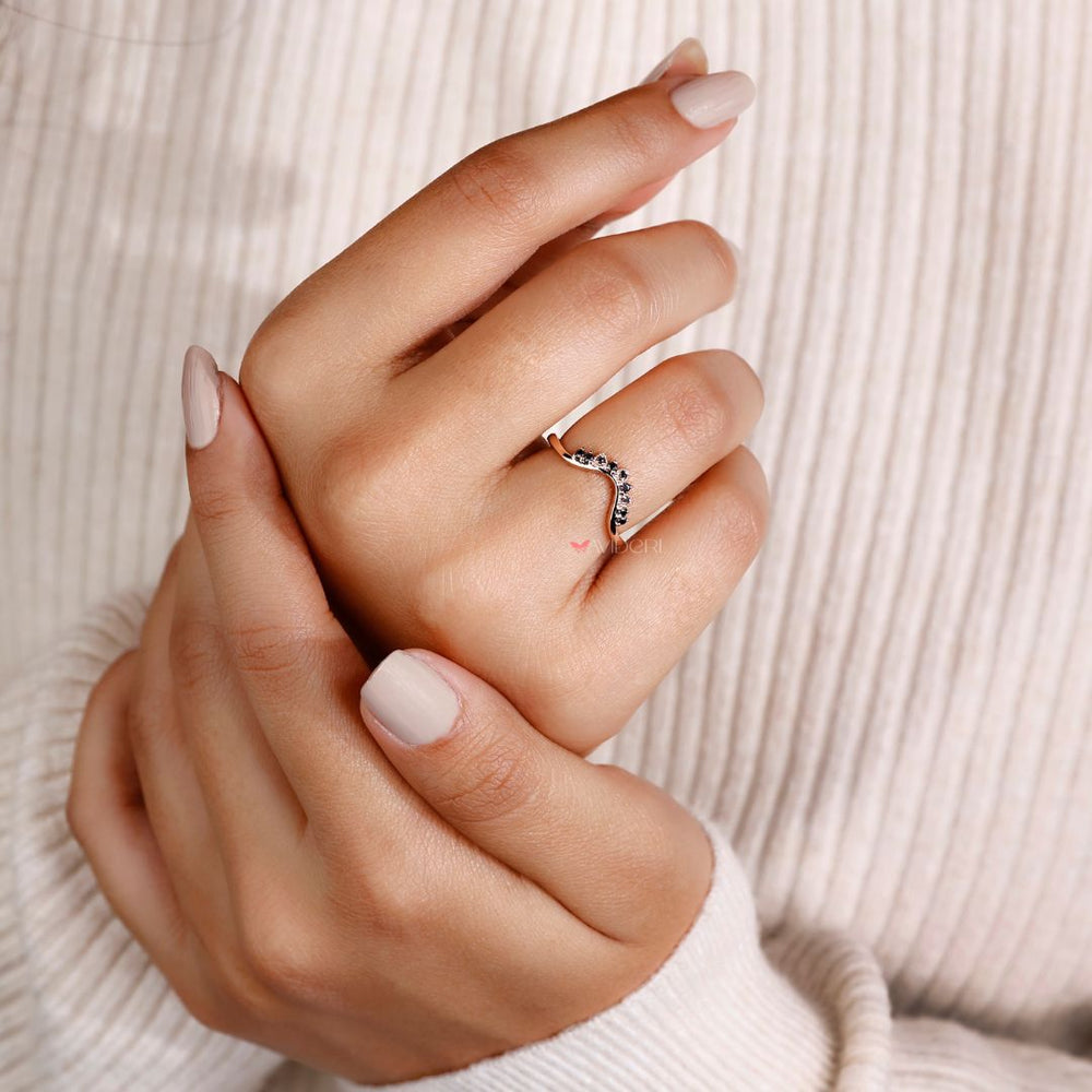 Curved wedding ring with a smooth design.