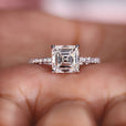 Asscher cut diamond ring with pave style band.
