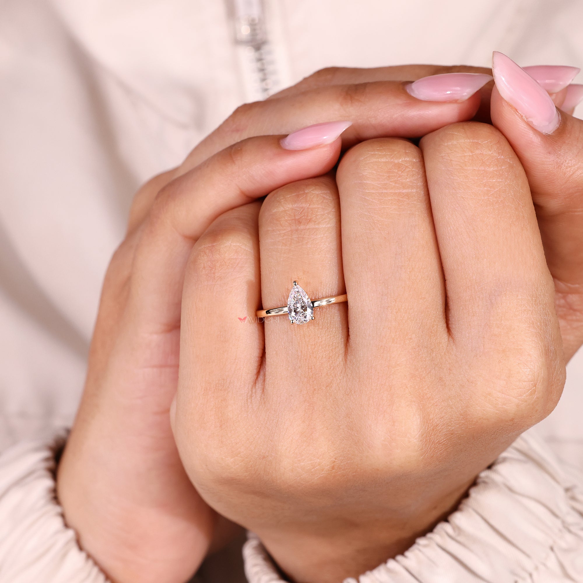 Pear cut diamond ring with sleek three prong setting.
