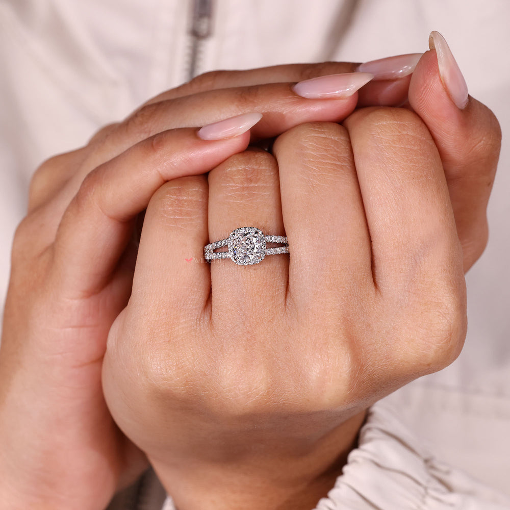 Cushion cut diamond ring with round pave halo.
