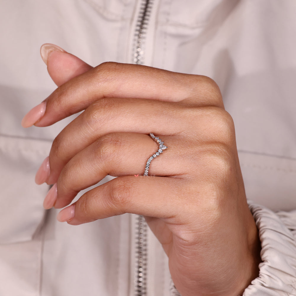 Chevron diamond band with pear and round stones.
