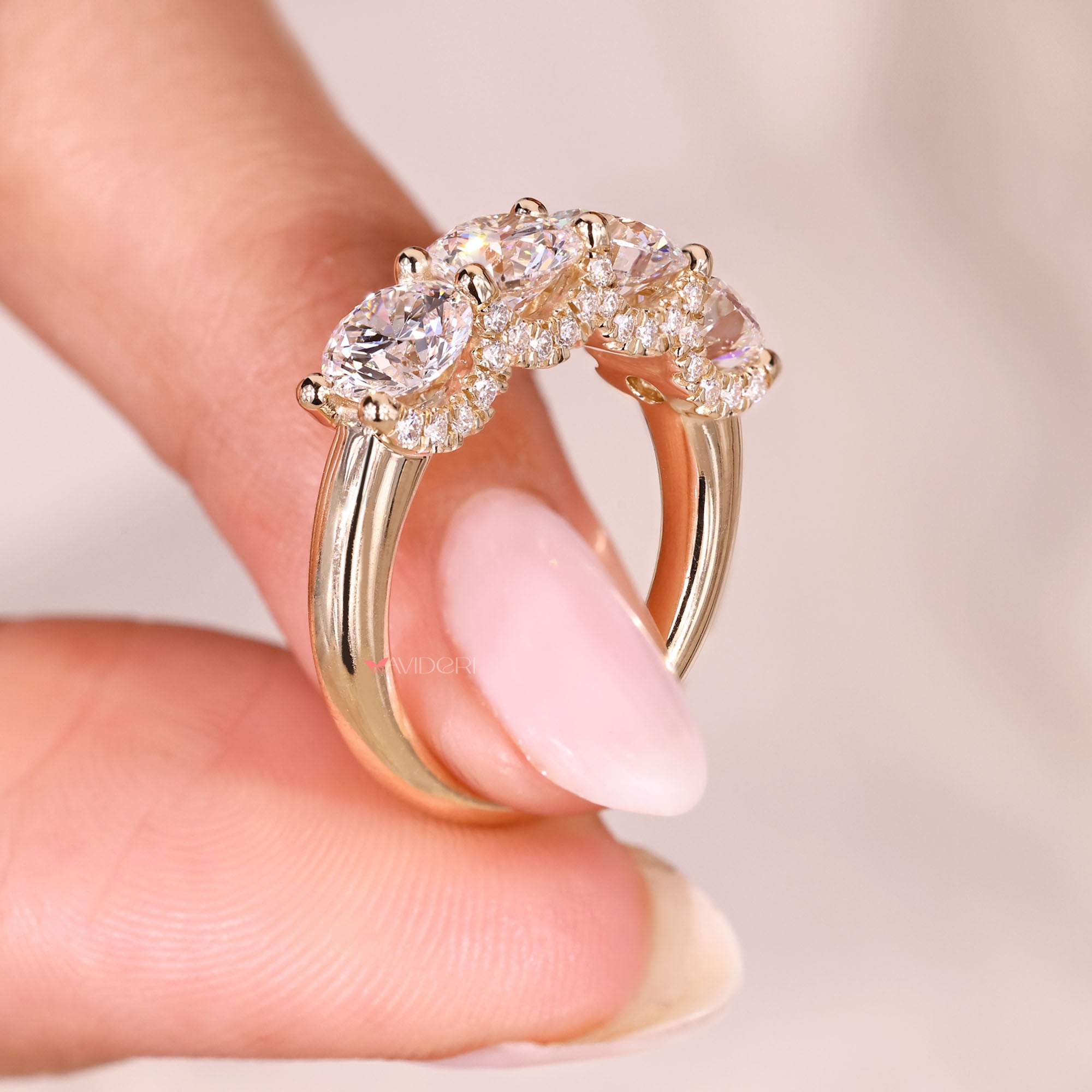 Lab grown round diamond wedding band with four stones.

