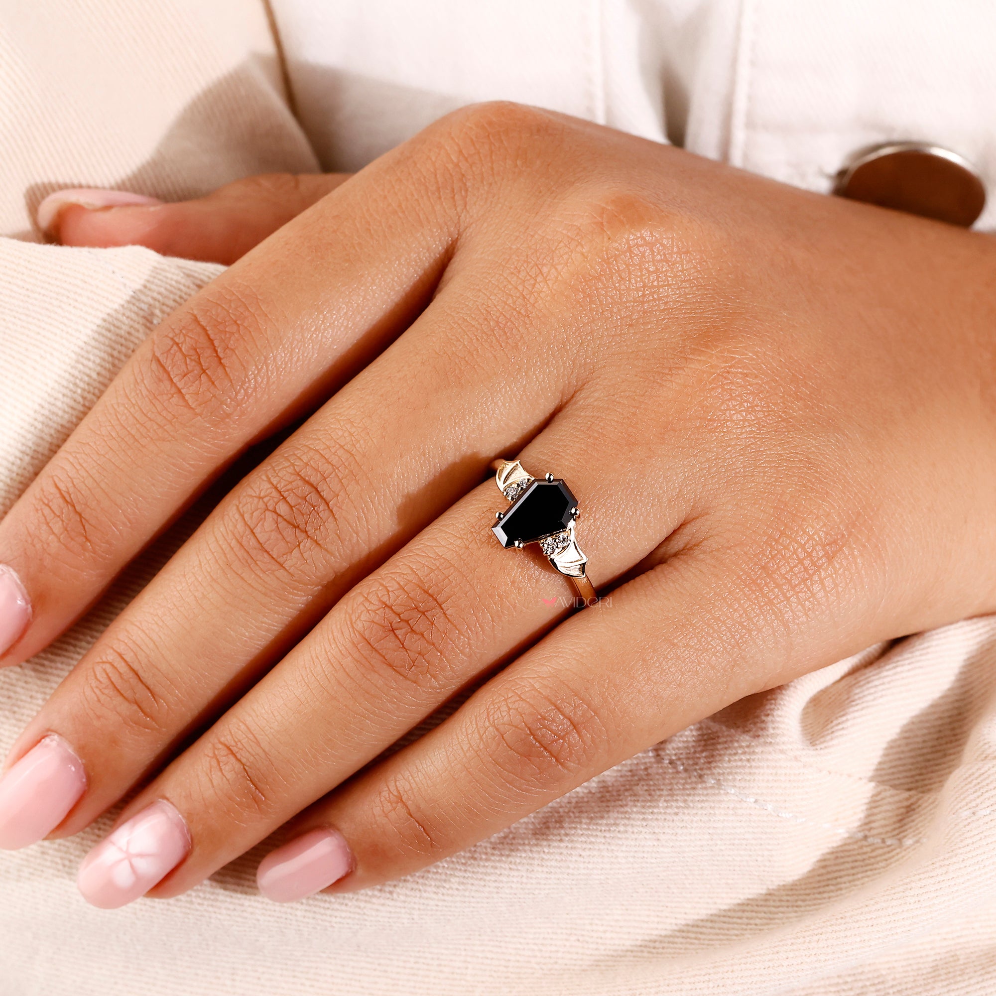 Black coffin engagement ring in round cut side stone.