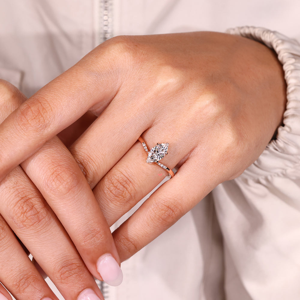 Marquise diamond ring with secure v prong detail.
