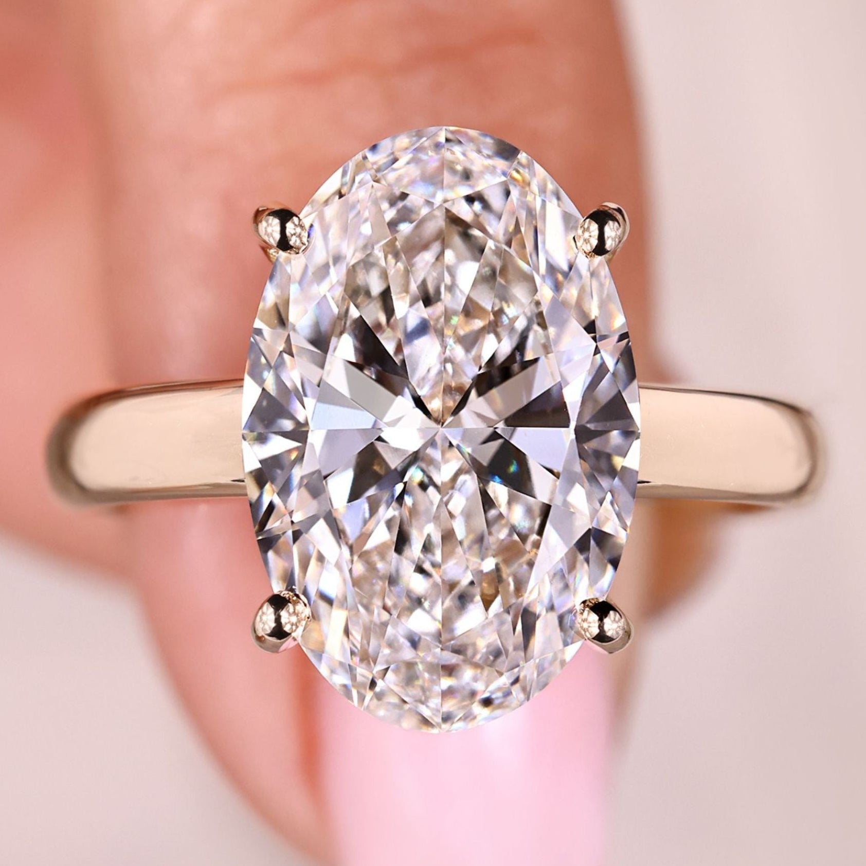 Lab grown oval cut hidden halo diamond ring.
